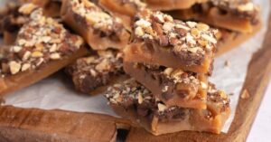 Homemade Toffee with Chocolate Chips, Almond Nuts in a Wooden Board