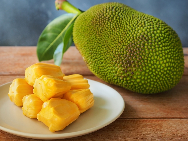 Jackfruit Whole and Peeled on a Wooden Table