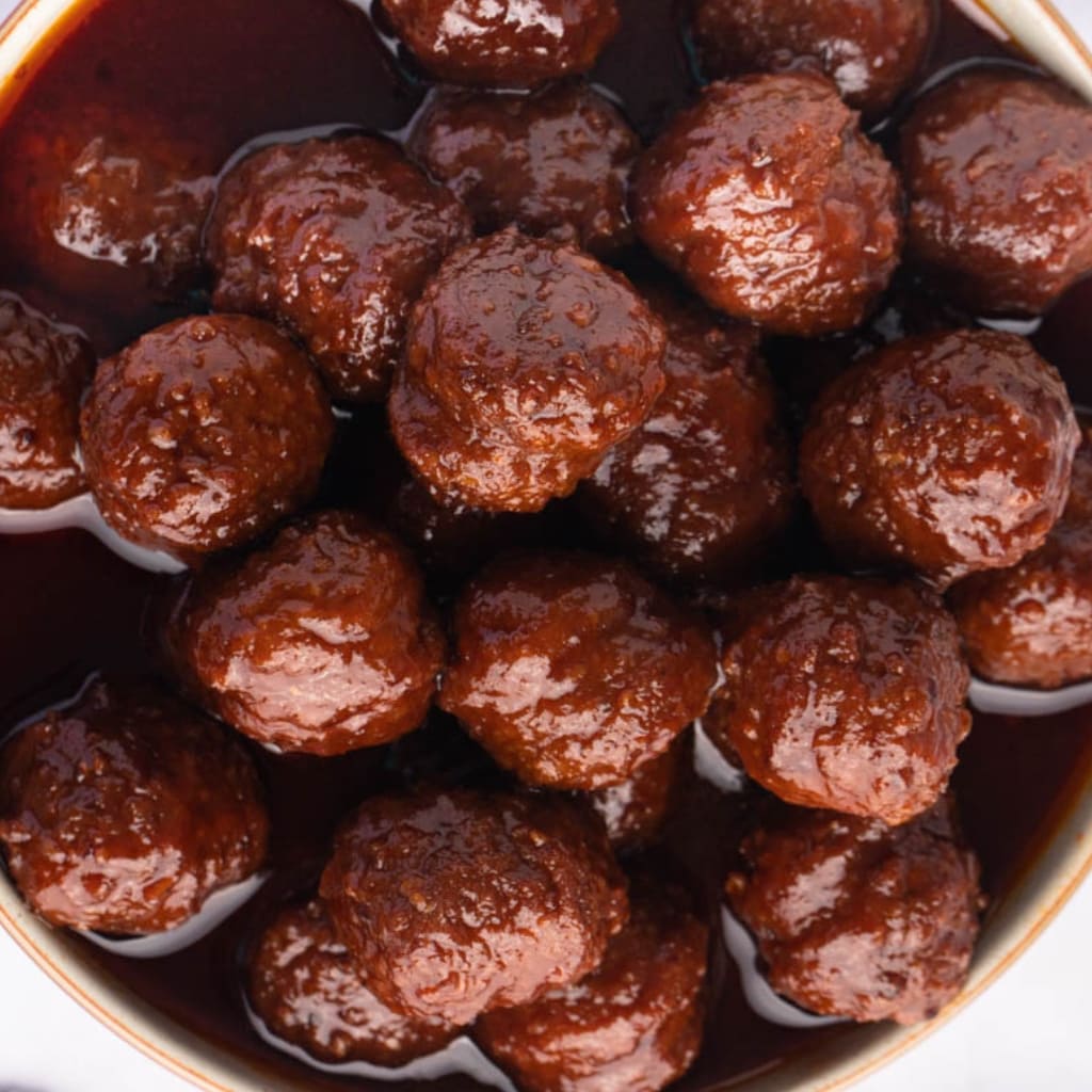 Close up of Grape Jelly Covered Meatballs in a Bowl