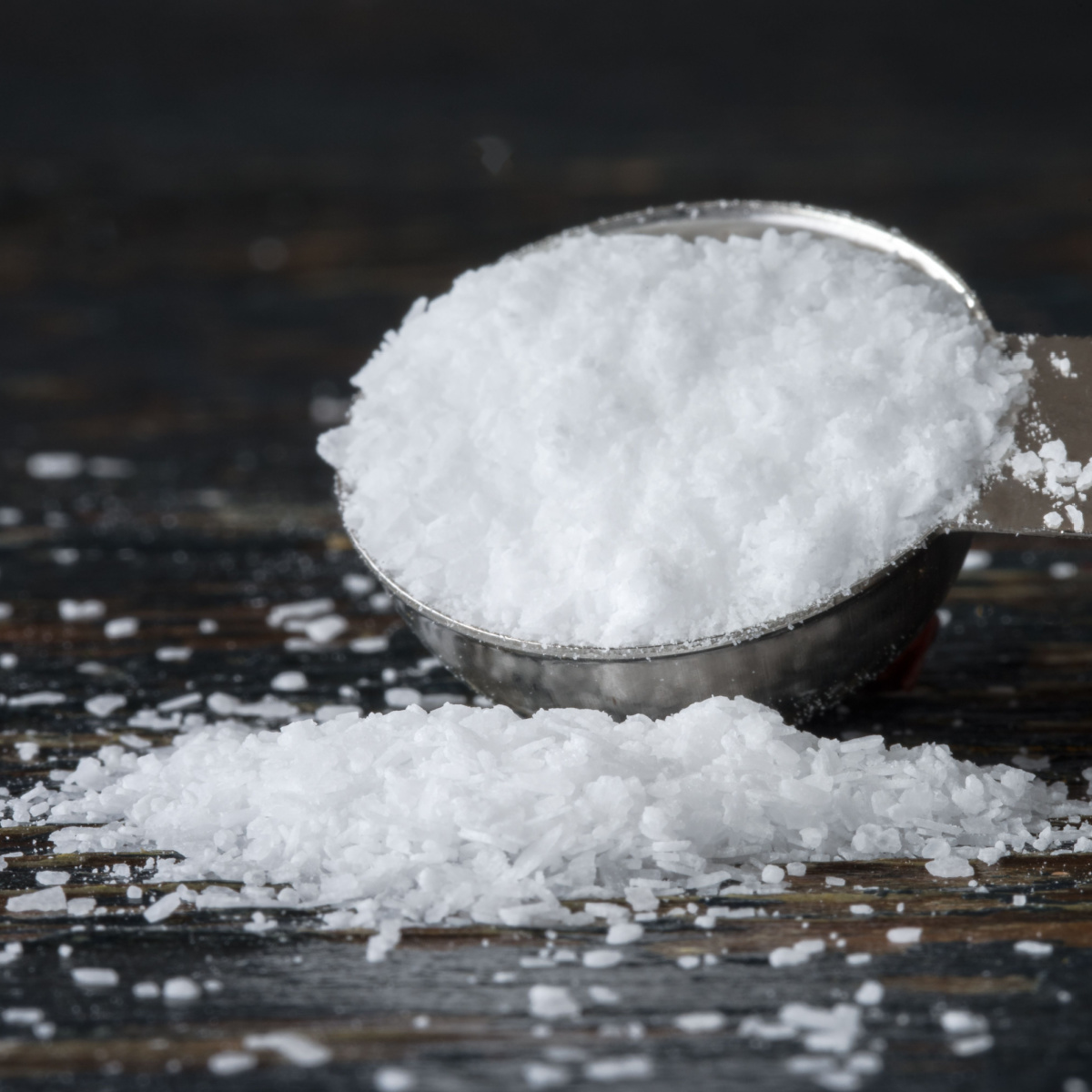 Salt Spilled on a Teaspoon an a Wooden Table - Kosher Salt vs Sea Salt: What's the Difference?