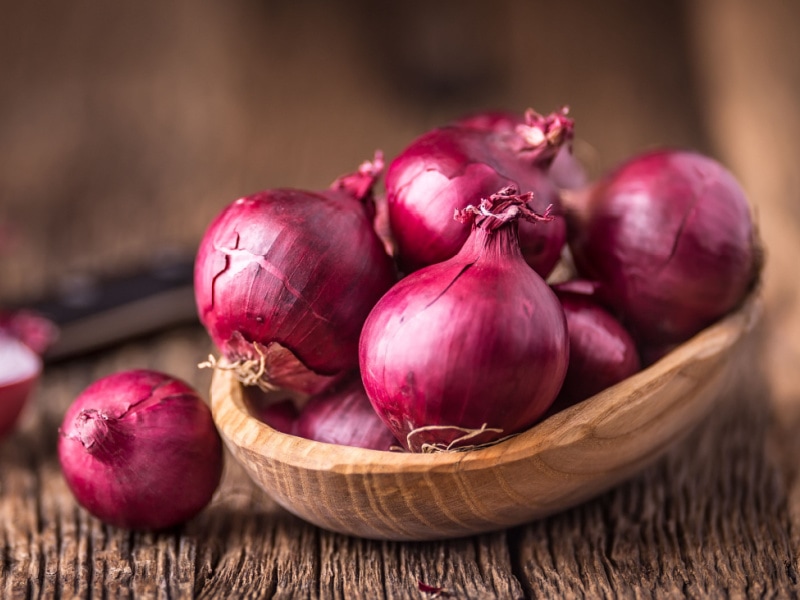 Red Onions in a Wooden Bowl