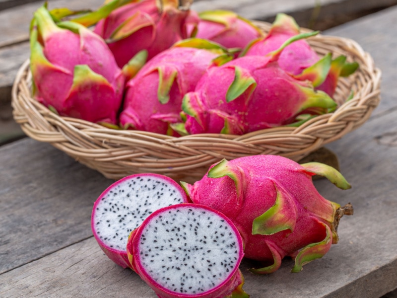Pitaya Whole and Slice on a Wooden Table