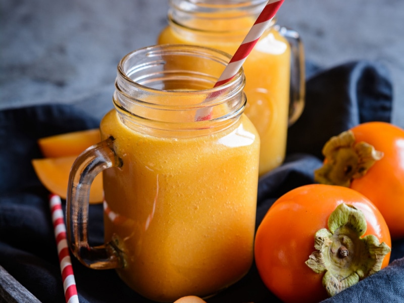Ripe Persimmon and Persimmon Smoothie on a Glass Jar
