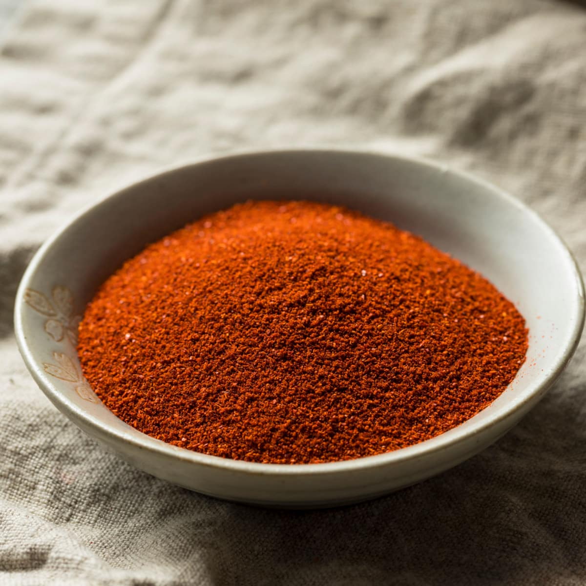 Portion of Sweet Paprika on a Wooden Saucer