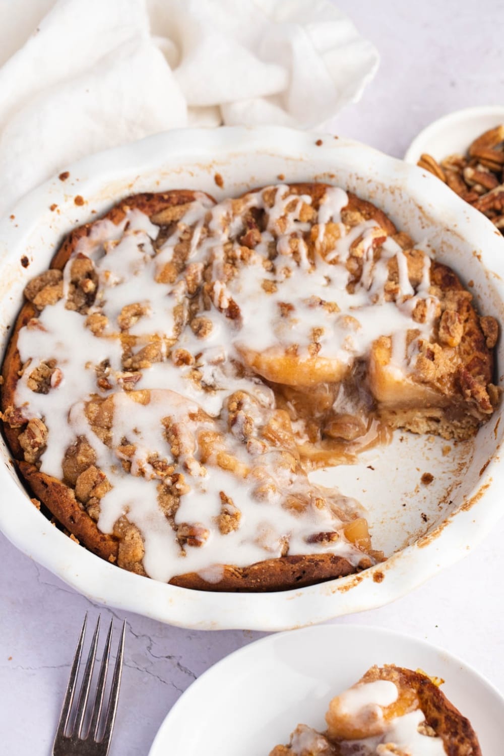 Soft and Fruity Cinnamon Roll Dutch Apple Pie Drizzled With White Cream on Top