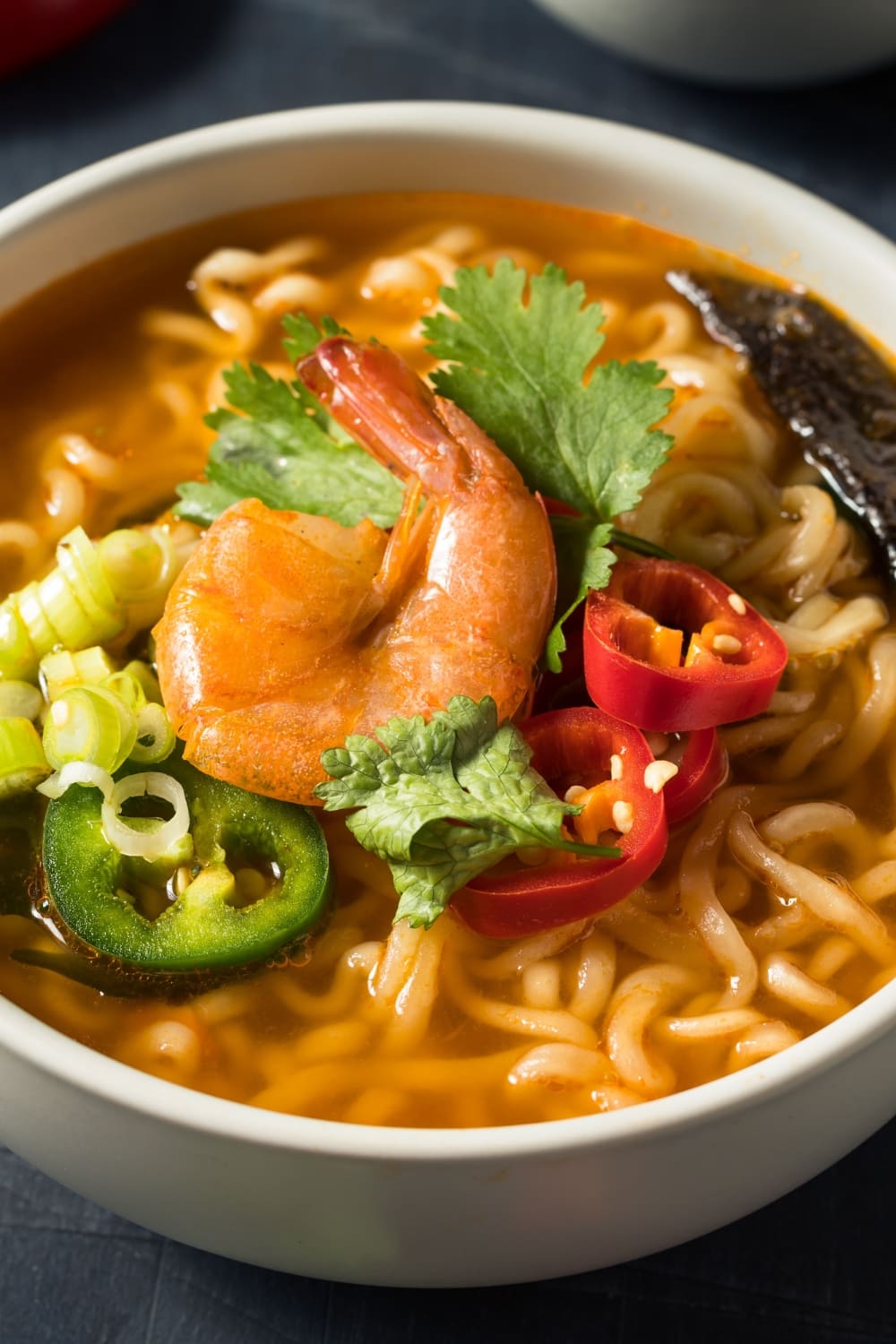 Spicy Seafood Ramen Noodle with Shrimp, Dried Seaweed, Fresh Parsley and Sliced Peppers