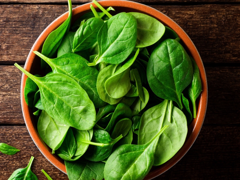 Fresh Spinach Leaves in a Wooden Bowl