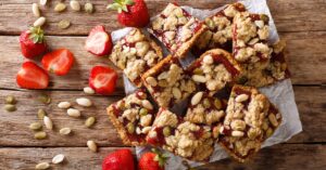 Strawberry Bars with Nuts in a Wooden Background