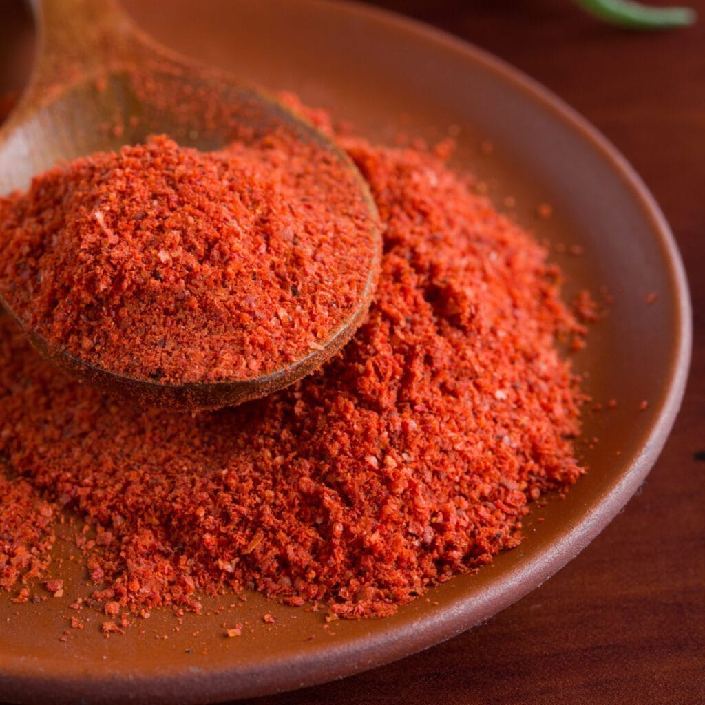 Portion of Sweet Paprika on a Wooden Saucer