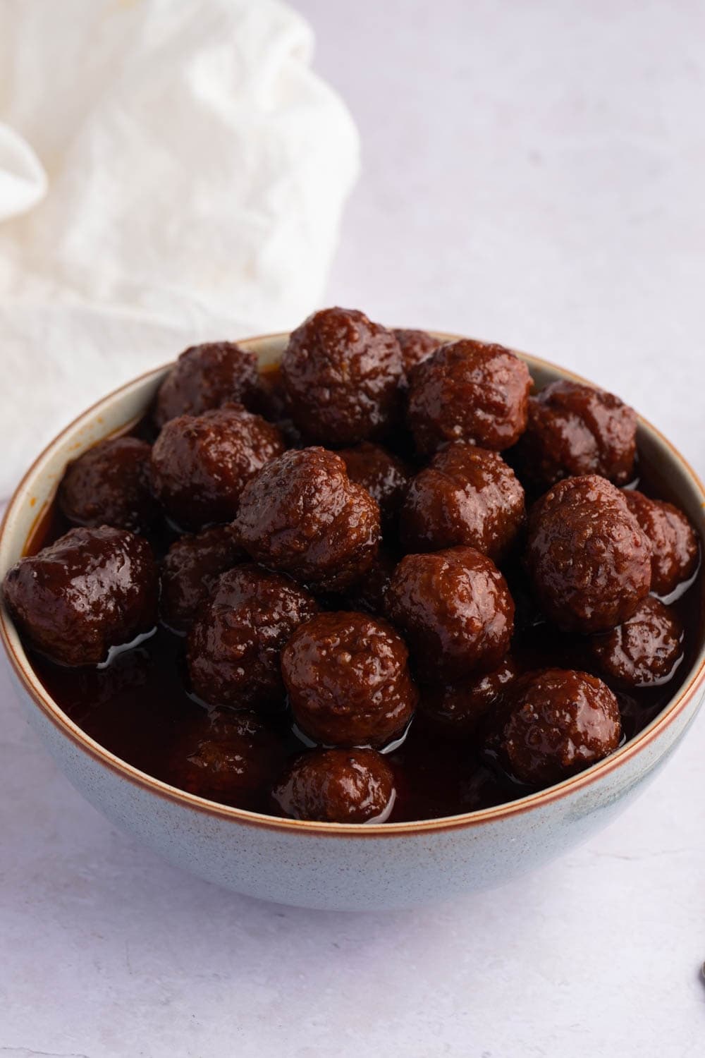 Bowl of meatballs served with grape jelly sauce.