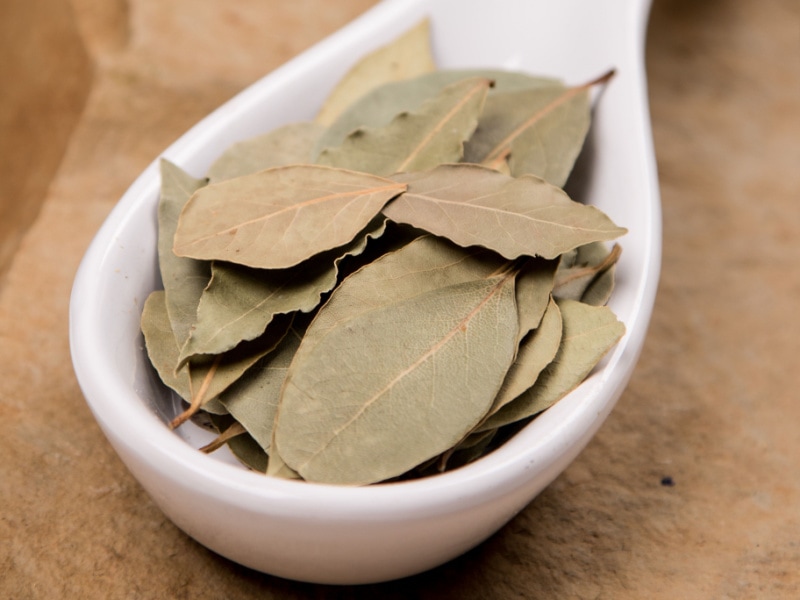 Dried bay leaves on a ceramic boat shape bowl