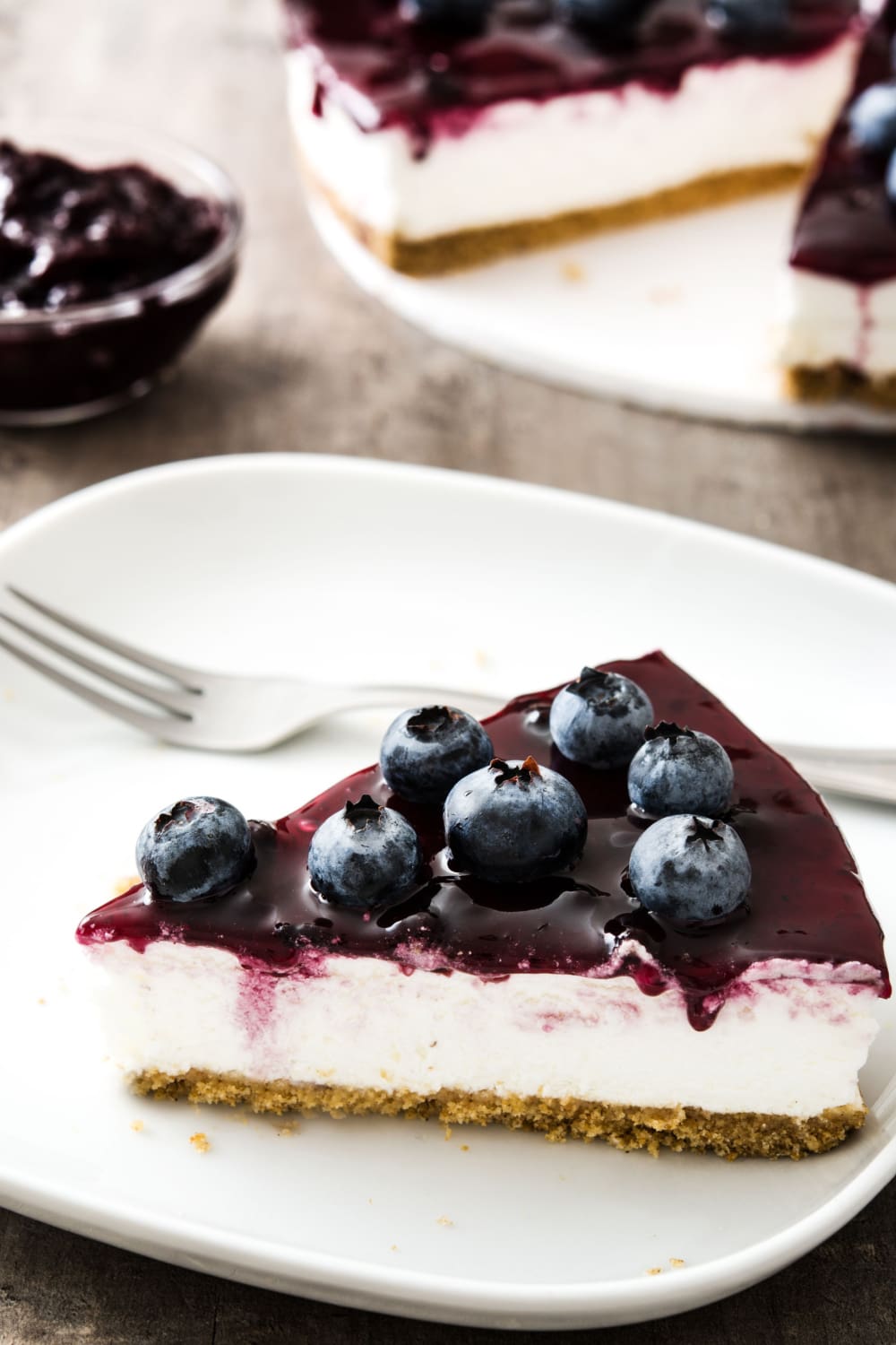 Slice of Blueberry Cheesecake on a White Plate