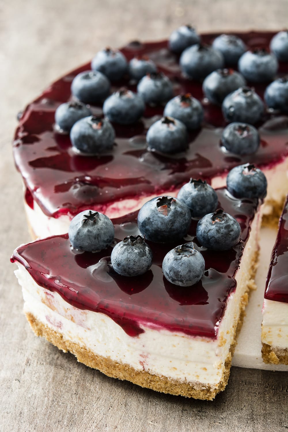 Sliced Whole Cheesecake Topped With Frozen Blueberries