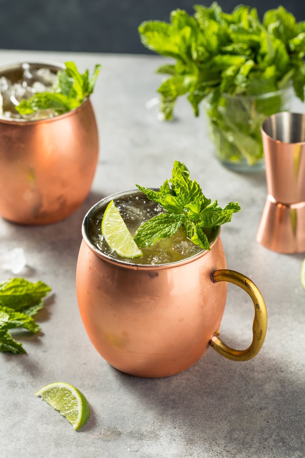 Ice Cold Boozy Refreshing Irish Mule Cocktail Garnished with Lemon Slices and Fresh Mint Leaves