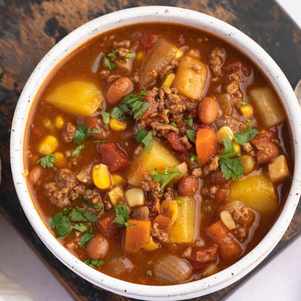 Bowl of Homemade Cowboy Soup with Ground Beef, Beans, Potatoes and Corn