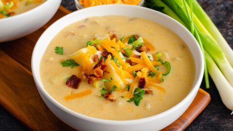 Bowl of Homemade Potato Soup with Cheese, Bacon and Green Scallions