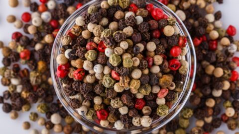 Bowl of Red, Green, White and Black Peppercorns