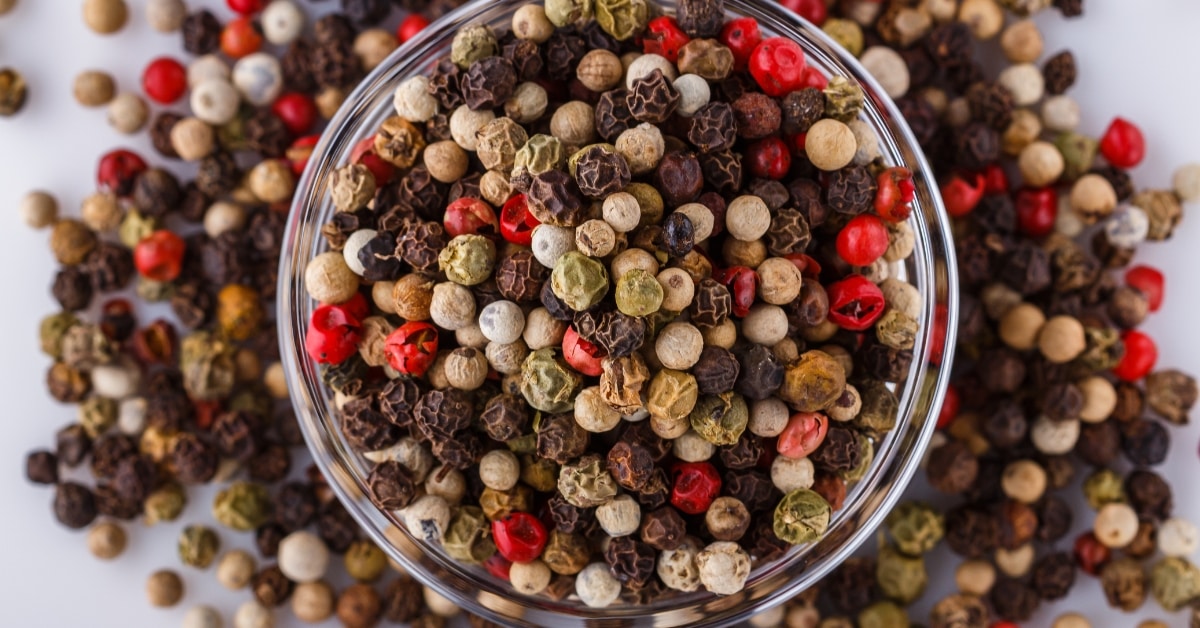 Bowl of Red, Green, White and Black Peppercorns