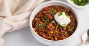 Bowl of Homemade Taco Soup with Ground Beef, Beans, Corn, Chiles and Sour Cream