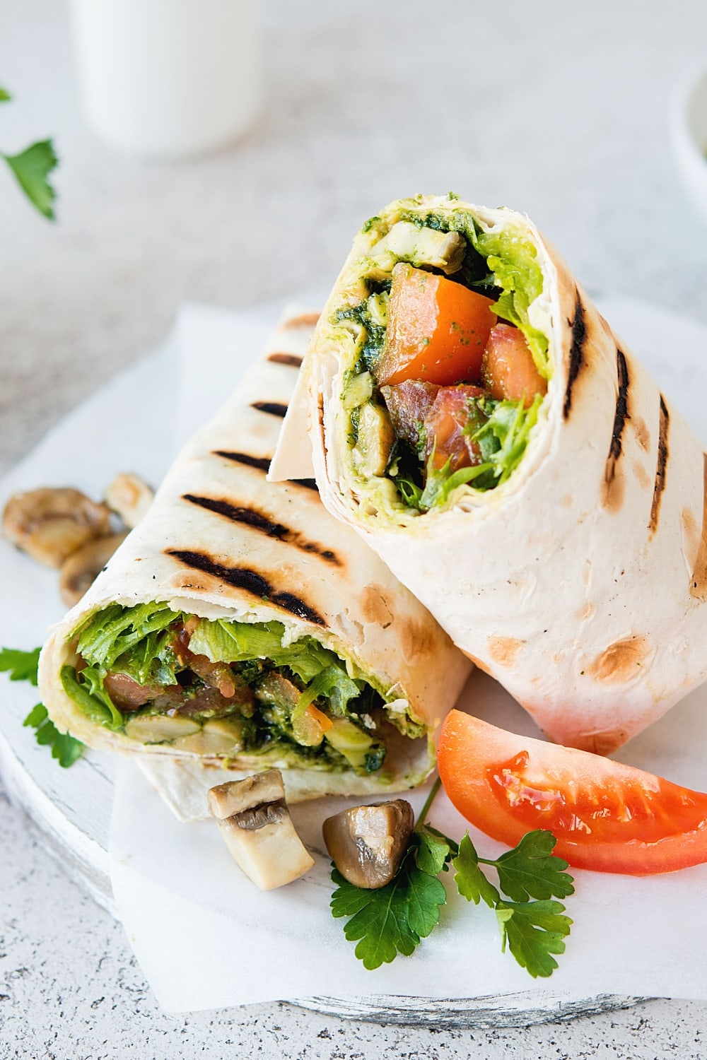 Burritos Wraps Sliced in Half with Mushrooms, Tomatoes, Lettuce and Vegetables Fillings