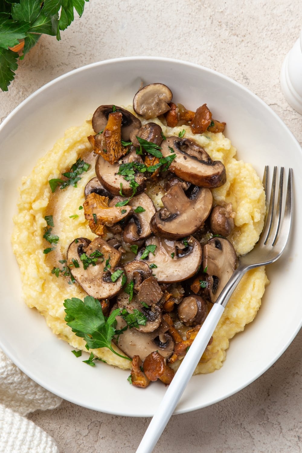 Top View of a Serving of Creamy Vegan Polenta with Fried Mushrooms on Top of Mashed Potatoes 