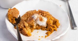Creamy and Buttery Pumpkin Cobbler in a White Plate