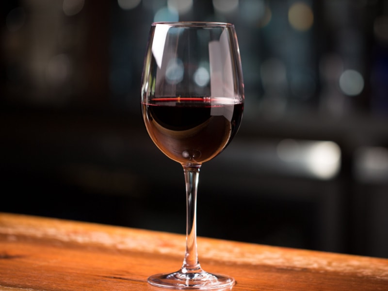 A Glass of Garnacha Wine on a Wooden Table