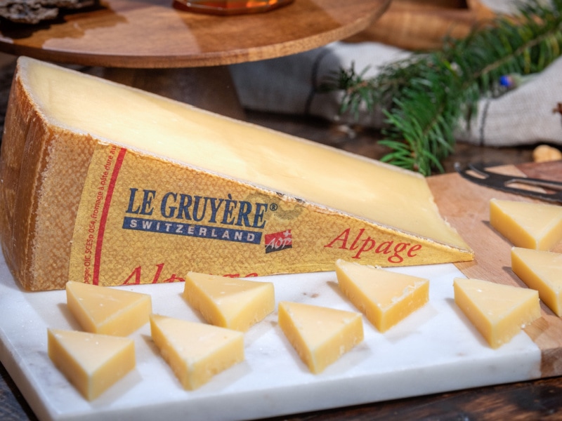 Pyramid Slices of Gruyere Cheese on a Cutting Board