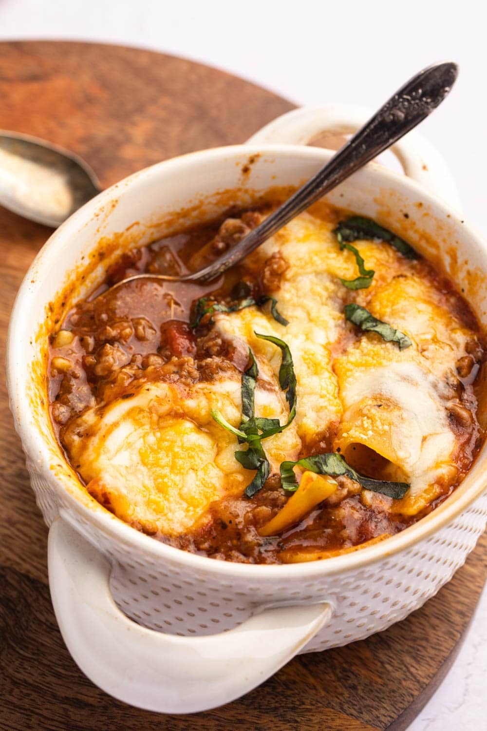 Cheesy Crockpot Lasagna Soup with Onions, Garlic, Tomatoes and Basil Served on a Ceramic Pot