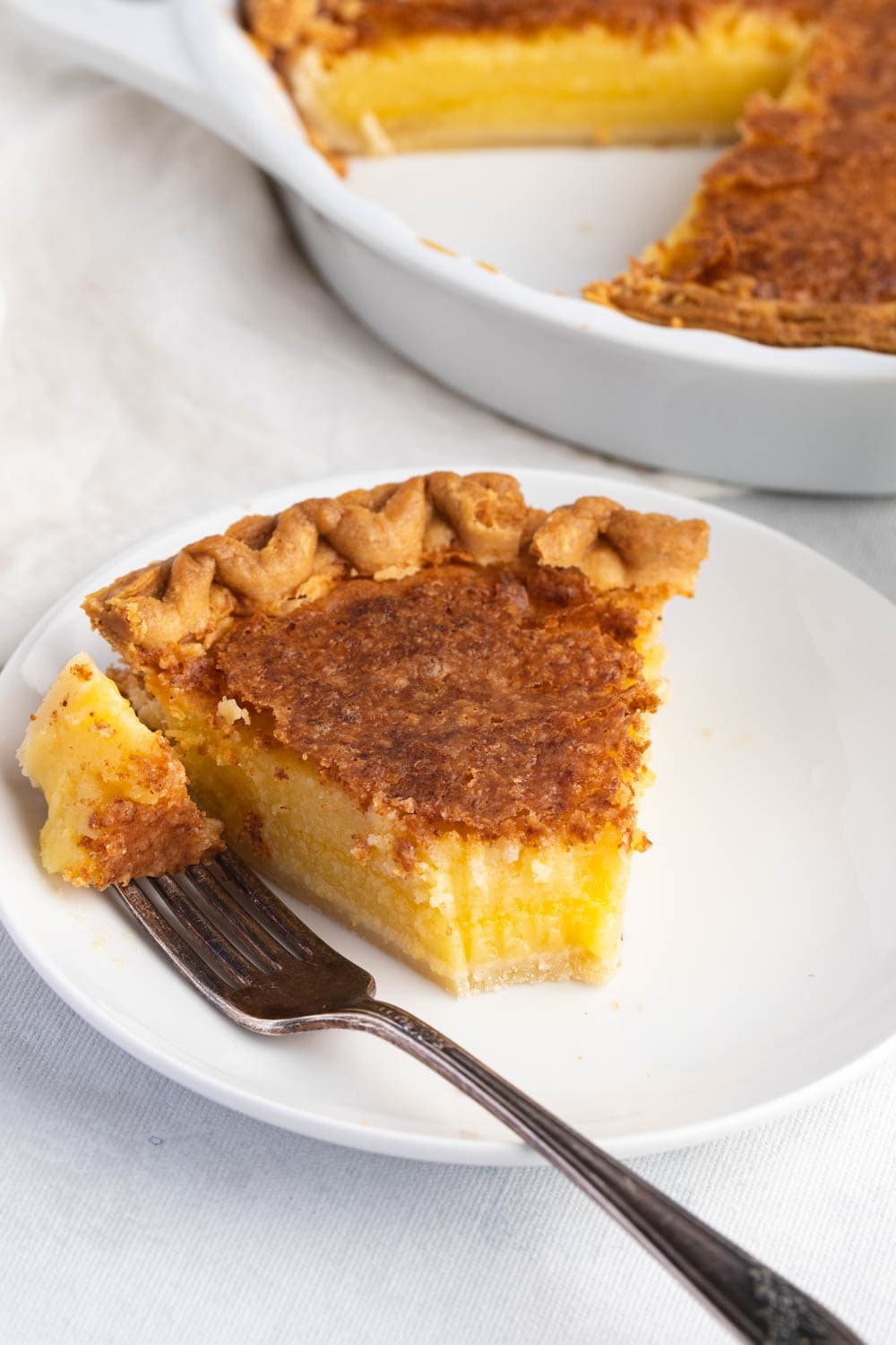 Homemade Sliced Chess Pie with Buttermilk in a White Plate