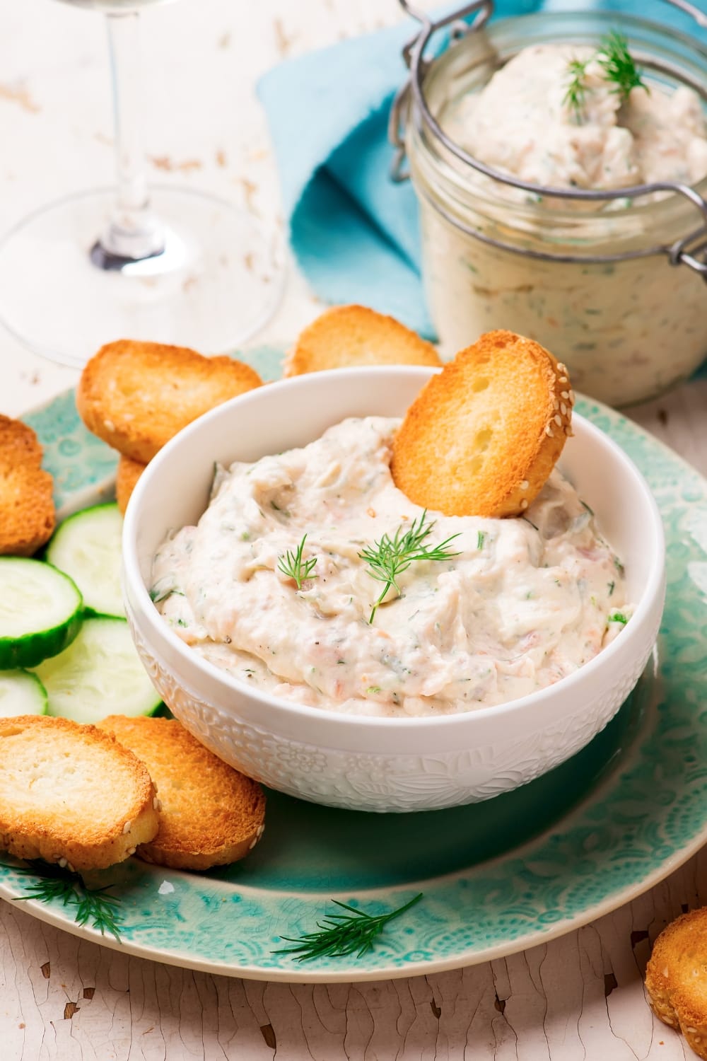 A bowl of smoked salmon dip with crunchy crackers.