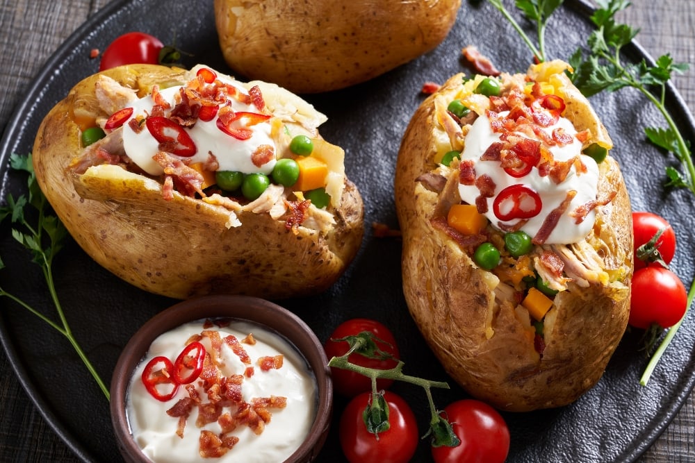 Homemade Twiced Baked Russet Potatoes with Bacon, Chili, Green Peas and Sour Cream