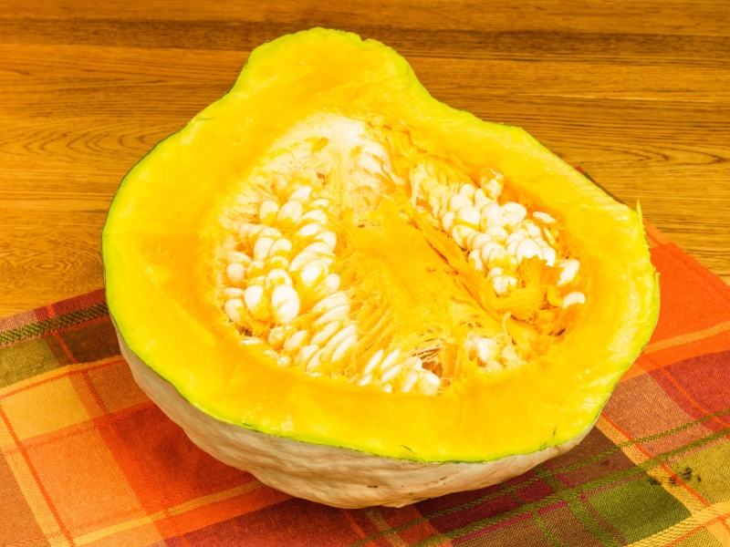 Hubbard Squash Cut in Half on Top of a Table Cloth