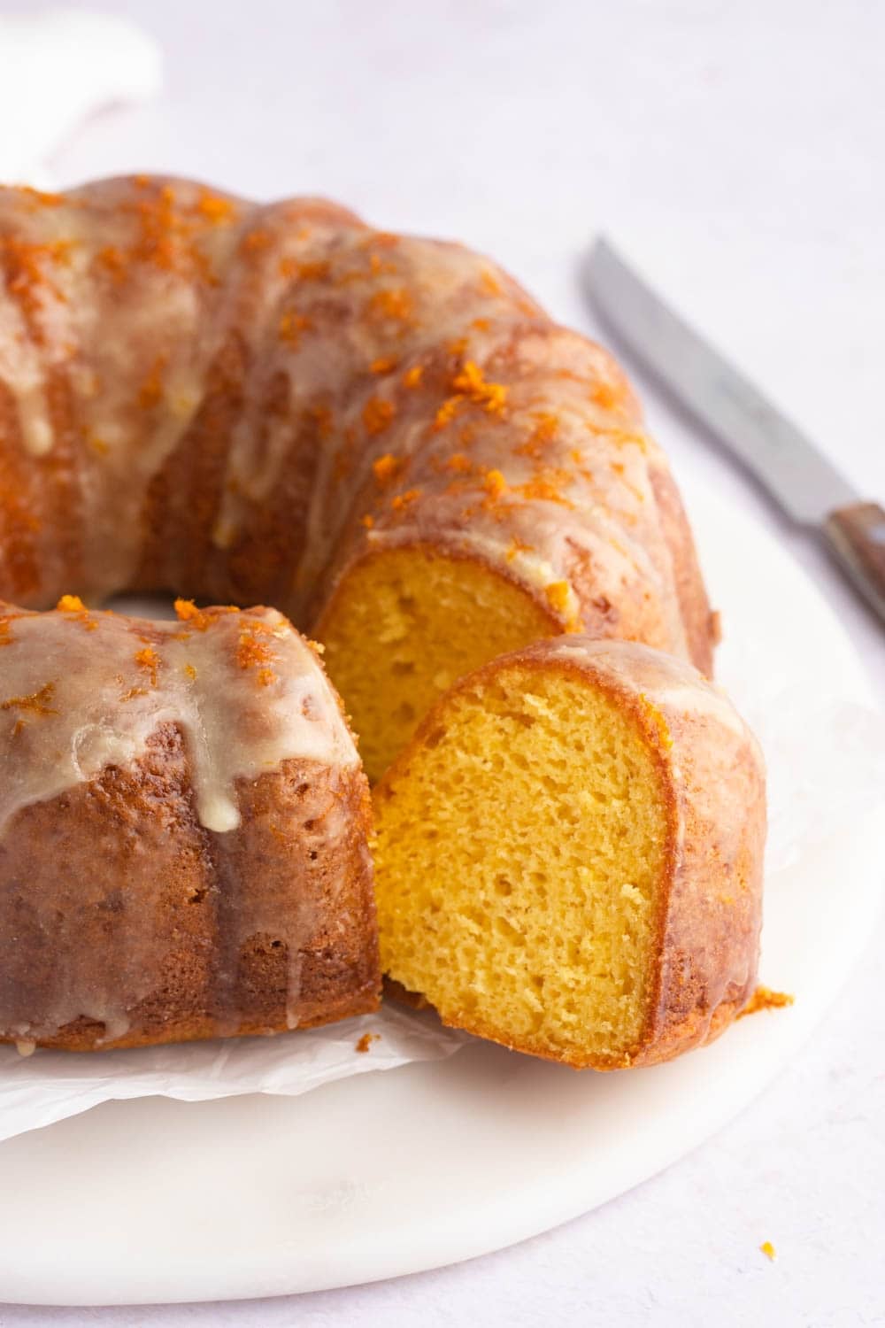 Moist and Fluffy Orange Cake with Glaze, Portion Sliced, Drizzled With Cream Sugar and Orange Zest