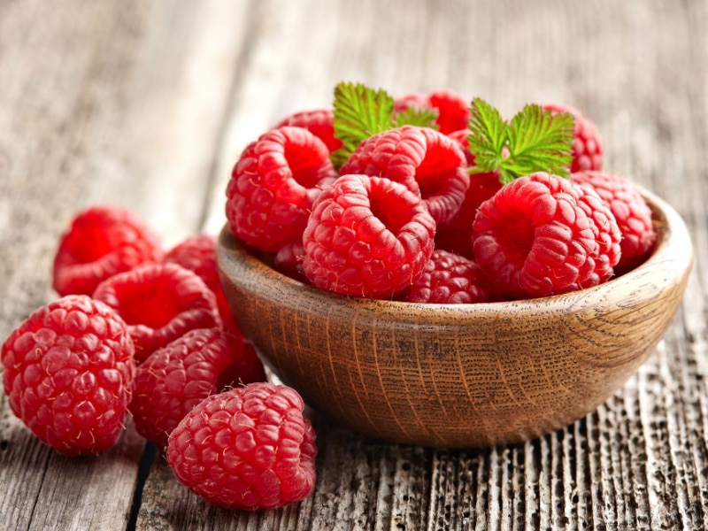 Bunch Fresh Raspberries in a Small Wooden Bowl