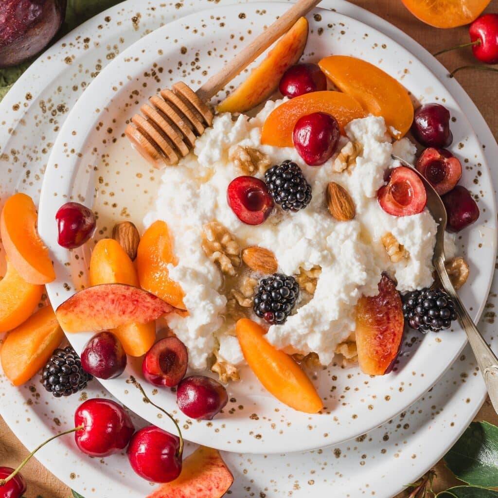 Ricotta Cheese with Stone Fruits Including Peach, Blackberries and Cherries Served on a Bowl