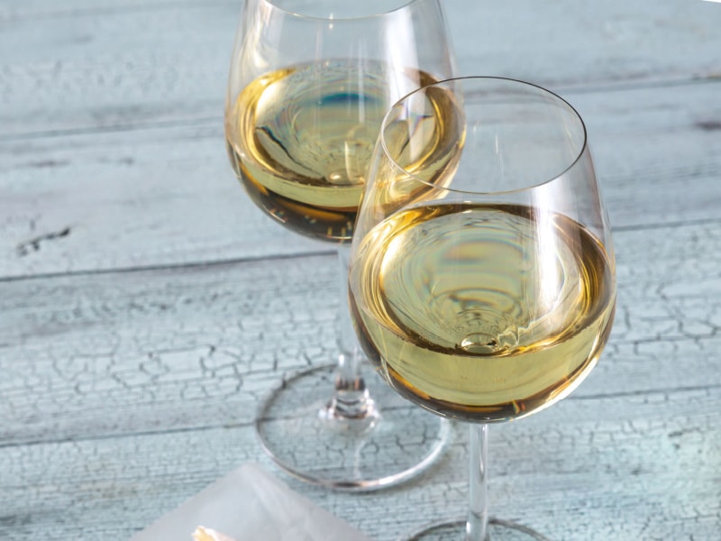 Two Glasses of Sauvignon Blanc on a Wooden Table