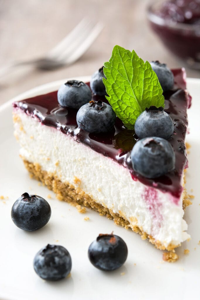 Slice of Blueberry Cheesecake Topped With Frozen Blueberries