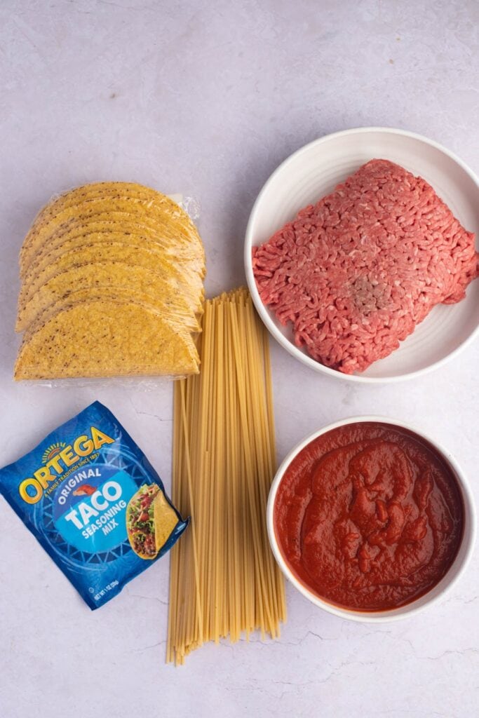 Spaghetti Tacos Ingredients - Ground Meat, Taco Seasoning, Water, Spaghetti Noodles and Taco Shells
