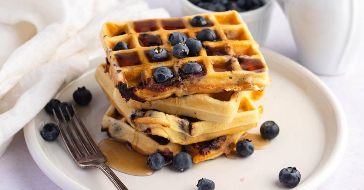 Stacked Homemade Blueberry Waffles with Honey
