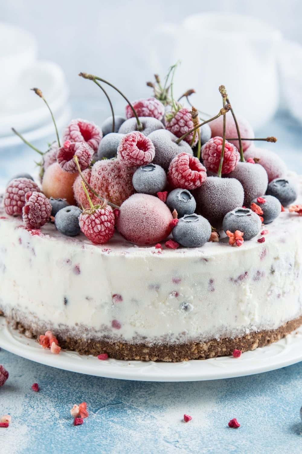 Sweet Cold Ice Cream Cake Topped with Frozen Fresh Berries, Served on a Pristine White Plate