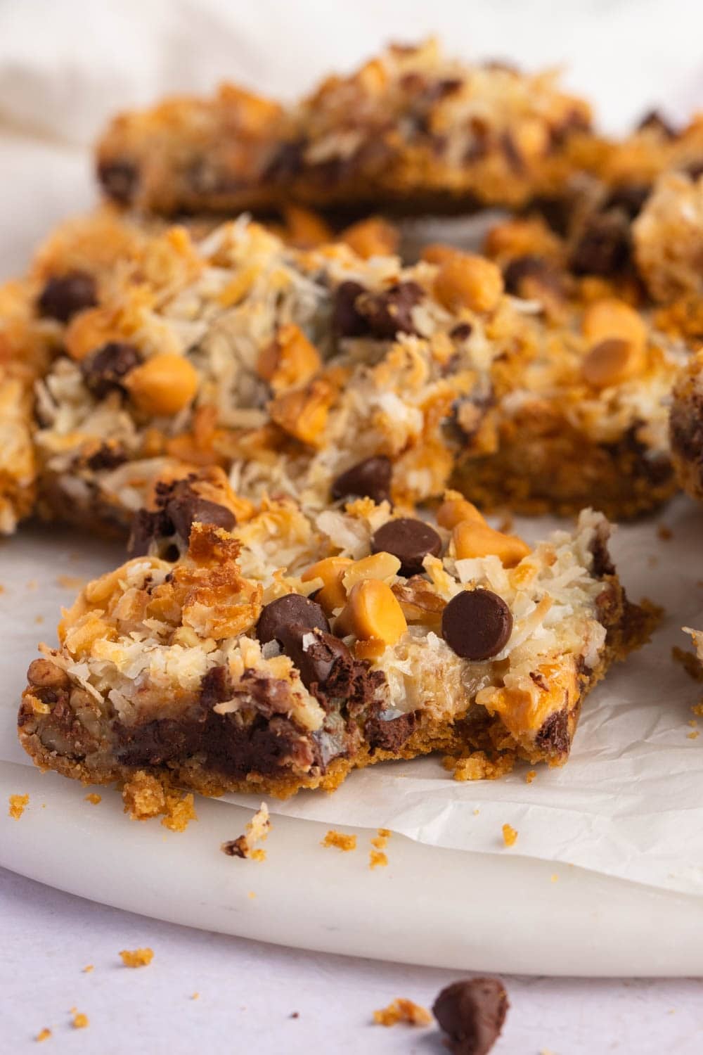 Sweet and Crumbly Seven Layer Bars with Chocolate Chips on a Parchment Paper