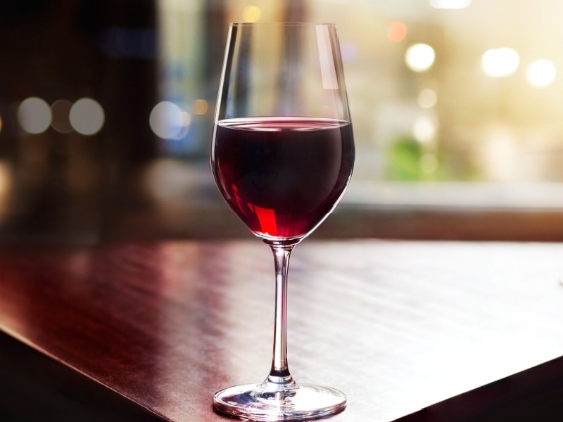 A Glass of Tempranillo on the Edge of a Wooden Table