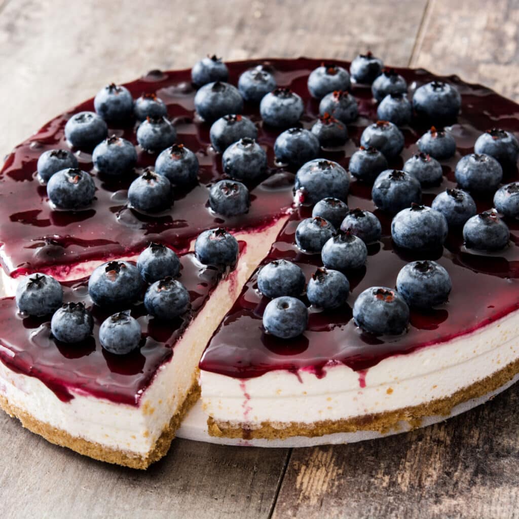 Blueberry cheesecake, topped with berries and melted jelly