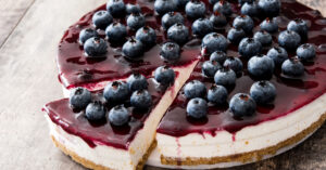 Whole Blueberry Cheesecake on a Wooden Table