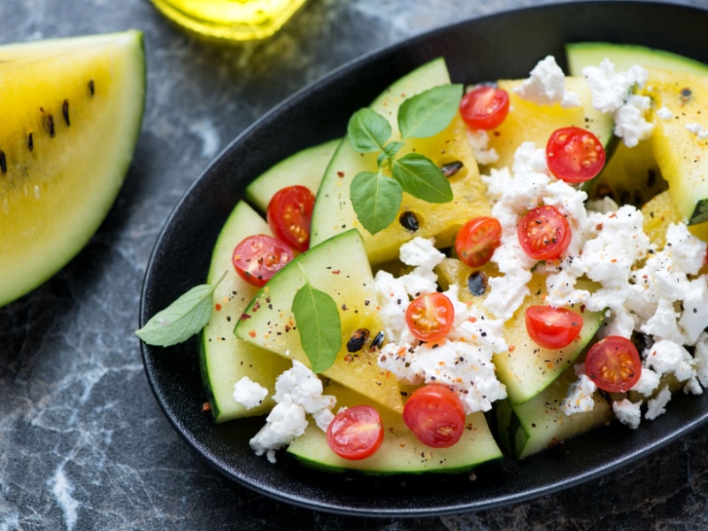 Yellow Watermelon Salad Made With Cottage Cheese, Sliced Tomato Cherries, Seasoned With Pepper