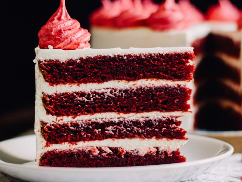 A Sliced of Red Velvet Cake with Frosting on Top