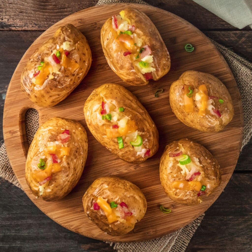 Baked Potatoes on a Round Chopping Board