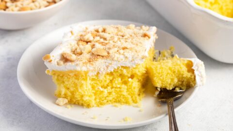 Banana Pudding Poke Cake with Crumbs in a White Plate