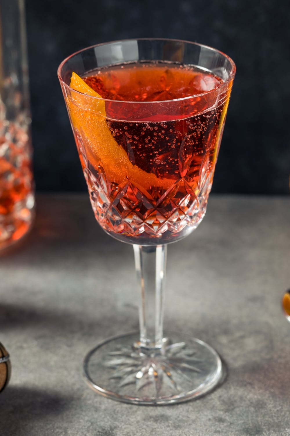 A Glass of Boozy Refreshing Negroni Cocktail Garnished with Orange Peel 